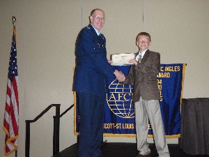 In August, Col. Curtis O. Piontowsky, USAF (l), former chapter president, honors Thomas Giacobbe, an AFCEA International Science Fair winner, with a commemorative plaque for his school.
